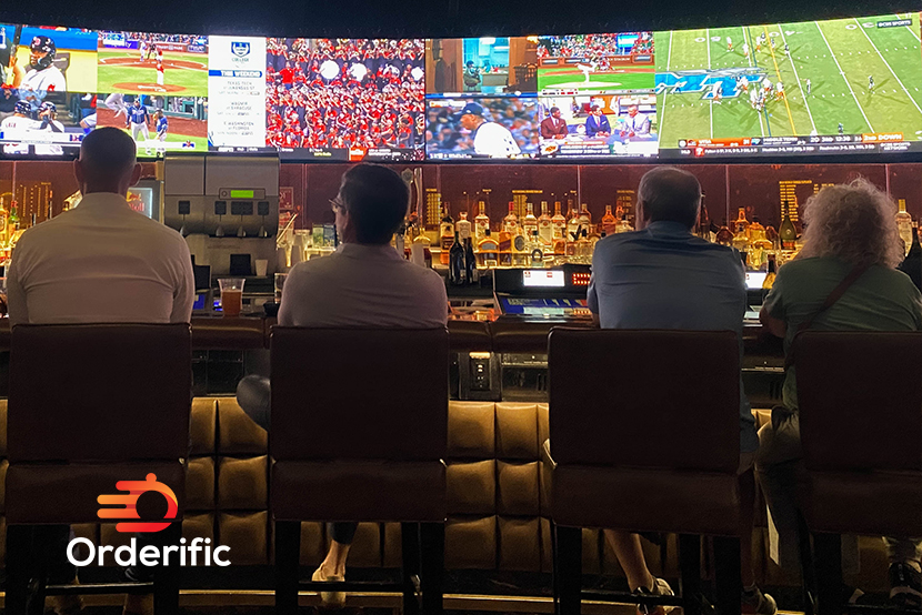 Sports Bars: Exploring the Appeal of this Unique Type of Eatery A group of men enjoying game night at a sports bar