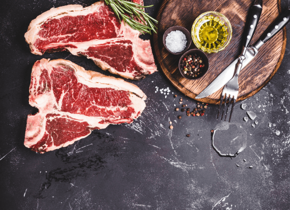 2 pieces of marbled steak ready to cook with oil pepper and salt